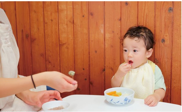離乳食を味わう赤ちゃん